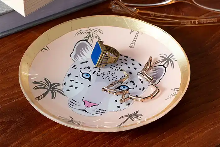 Leopard round shaped trinket dishes holding small jewellery items.