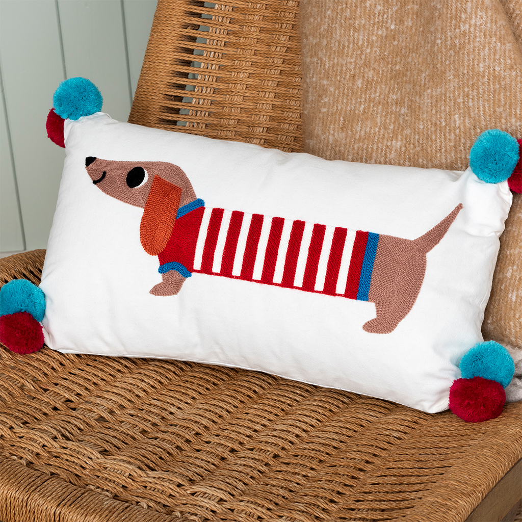 embroidered cushion with pom poms - sausage dog