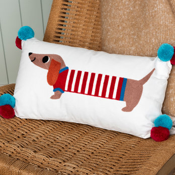 embroidered cushion with pom poms - sausage dog