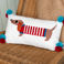 embroidered cushion with pom poms - sausage dog