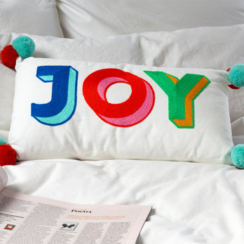 embroidered cushion with pom poms - joy
