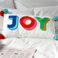 embroidered cushion with pom poms - joy