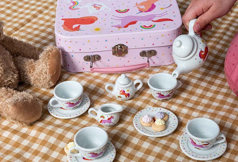 Ceramic toy tea set for children with colourful and vibrant unicorns, stars and rainbows featuring on each piece. 