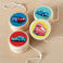 Wooden yoyos decorated with colourful vehicle designs, ideal for museum gift shops or children’s stocking fillers.