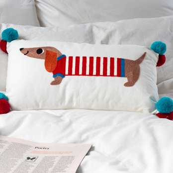 embroidered cushion with pom poms - sausage dog
