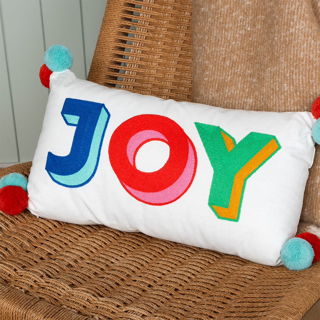 embroidered cushion with pom poms - joy