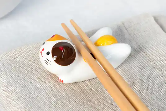 Adorable ceramic chopstick rest in the shape of a cat. 
