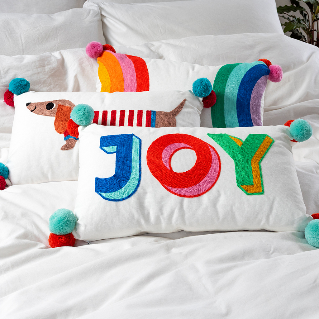 embroidered cushion with pom poms - joy