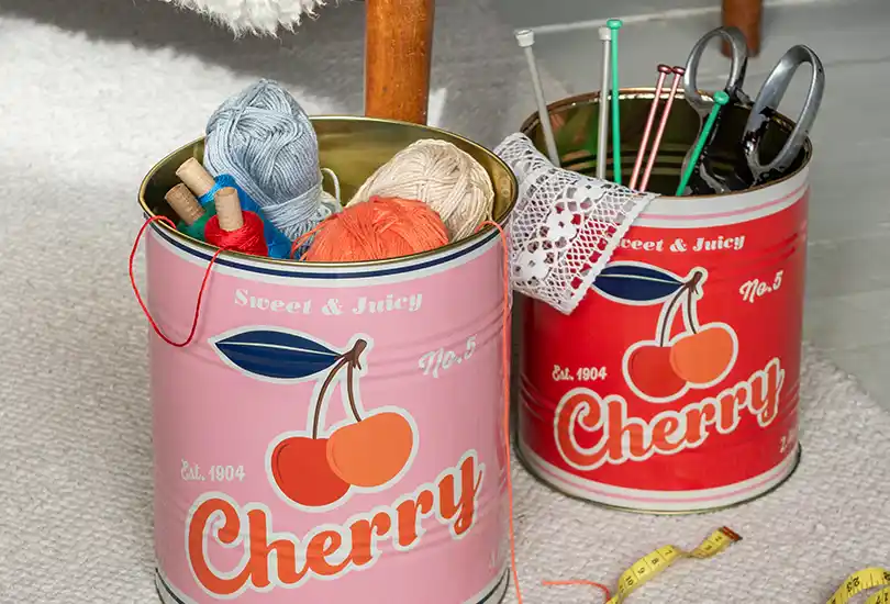 Cherry storage tins, Large tin in pink and a small tin in red.